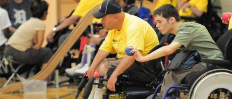 two players in wheelchairs tossing boccia balls.